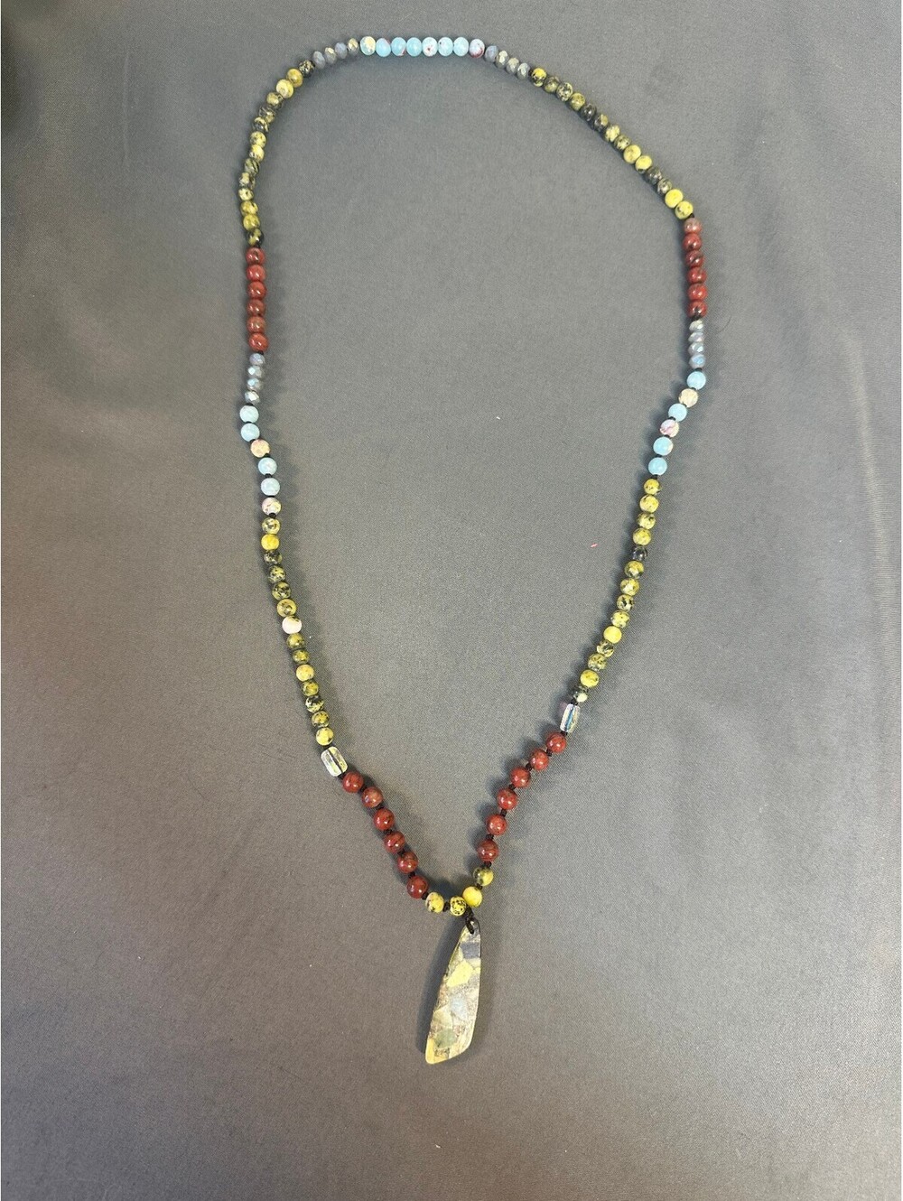 Beaded Necklace With Red Green and Blue Beads and Green Stone Pendant